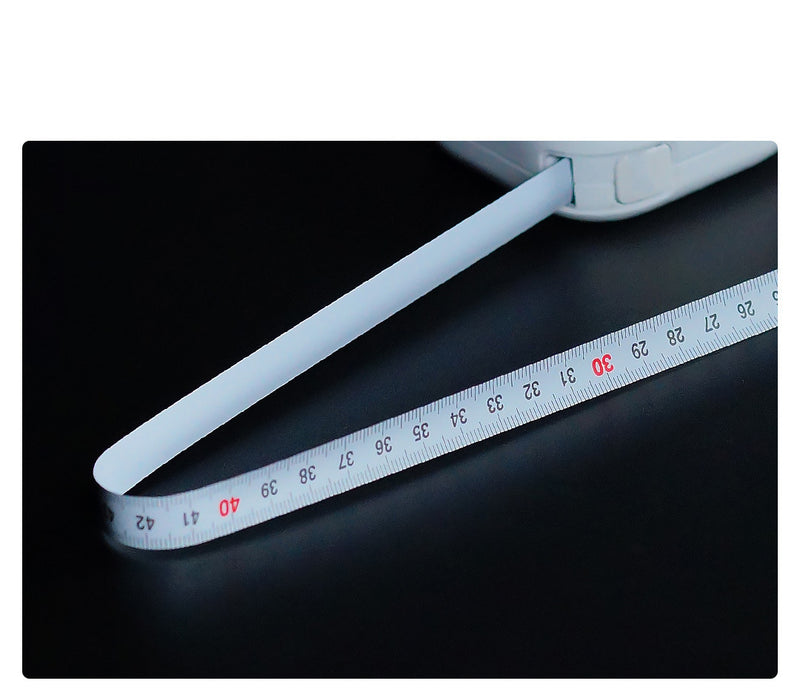 White measuring tape with red text on a black background